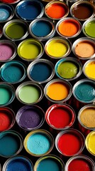 Fototapeta premium Vibrant paint cans filled with colorful pigments, overhead view of art supplies and renovation materials for creative home decor projects