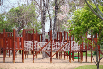 Wooden playground in garden on background