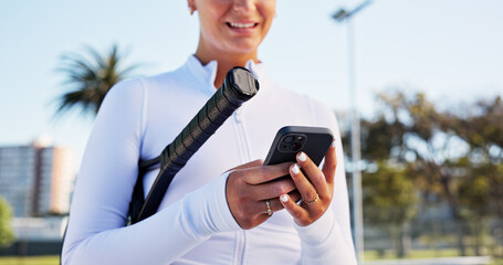 Hands, smile and woman with phone on tennis court for fitness, training app and match progress. Happy, female person and mobile for sports notification, video demonstration and online tips for game