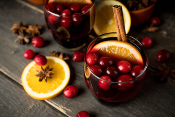 Mulled wine with ingredients on rustic wooden background. Selective focus.