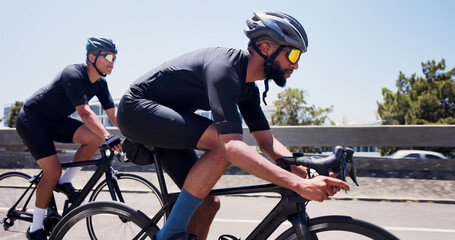 Men, bicycle and team on bridge in city, speed and helmet for workout with sunglasses in summer. People, cycling and bike on road, triathlon training or outdoor with cardio challenge in urban town © EineroLens/peopleimages.com
