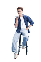 Modern Communication: A young individual, smartly dressed and with a modern accessory, is seated, speaking into a device, capturing a moment of contemporary communication.