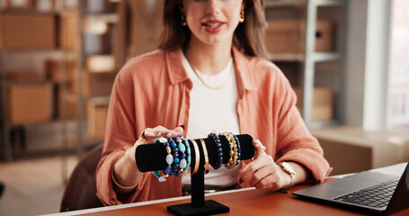 Hands, jewelry and dropshipping with laptop, review and point on live stream for collection on sale. Woman, entrepreneur and computer with accessory, ecommerce and recording video promo at startup