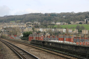 Fototapeta premium Suburban Railway Tracks and Residential Townscape under Cloudy Sky 