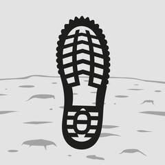 Black boot print on textured gray surface with craters.
