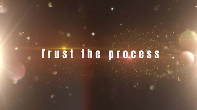 Inspirational motivational quote trust the process appearing over a dramatic sparkling lens flare background animation