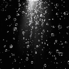 Obraz premium suspended water droplets and bubbles lit by shafts of light against a deep black background, sparkling and rising with a serene, ethereal, mysterious mood