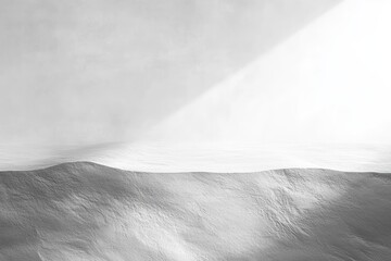 Minimal monochrome landscape of undulating textured dunes lit by a soft diagonal beam, deep shadows and serene calm evoking solitude