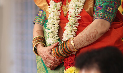 Tamil brahmin wedding -close up of hands performing pooja in indian tradition