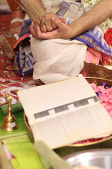 Tamil brahmin wedding -close up of hands performing pooja in indian tradition