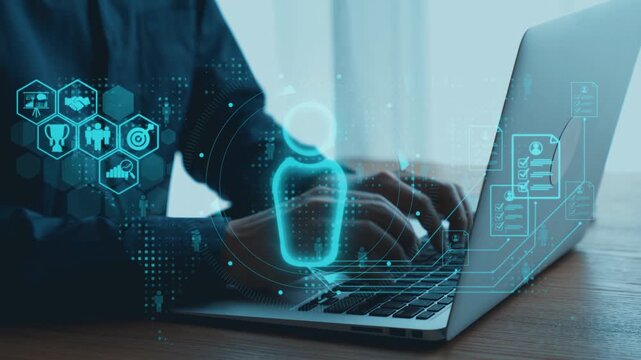 A user interacts with a laptop, highlighted by holographic icons representing data and communication. This image encapsulates the essence of modern technology and innovation. Qubit