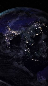 Night side of the Earth with city lights. Zoom in Asia countries. Vertical video. Elements of this image furnished by NASA