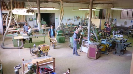 Artisan carpenter working with wood in a carpentry workshop