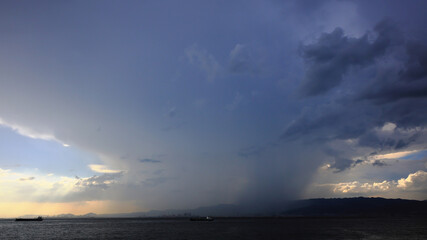 Sudden heavy rain on a summer evening, violent thunderstorms sweeping across the mountains