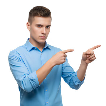 Young man in blue shirt pointing with both hands at copy space.