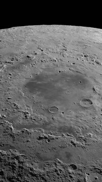 Camera flies around a craters in the Moon. Vertical video. Elements of this image furnished by NASA's Scientific Visualization Studio.