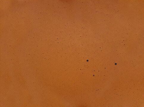 Close-up brown coffee crema pattern texture, from espresso shot