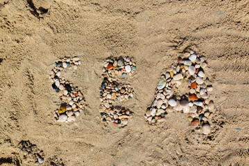 Word Sea written in the sand on the beach. Summer travel concept