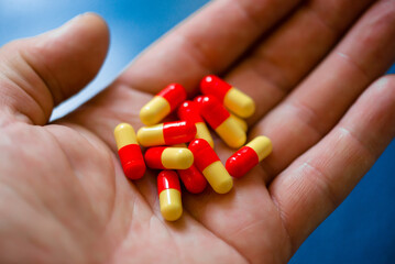 Red medicinal capsules in the Palm of your hand