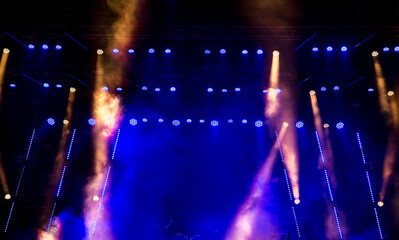 Stage light with colored spotlights and smoke.