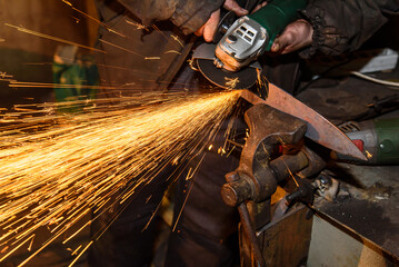 Blacksmith, knife sharpening, sparks, metal. Forging molten metal. Making knives.forge workshop
