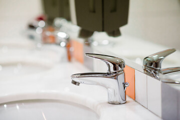 Bathroom interior with white sink and faucet.