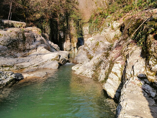 Caucasus, a river with a waterfall in the mountains