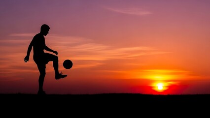 Silhouette of soccer player kicking ball at vibrant sunset