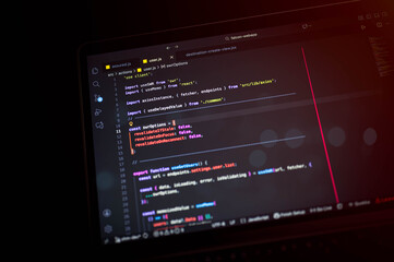 Close-up of JavaScript code on a laptop screen using React and Axios in a dark theme IDE environment, representing modern web development and programming concepts.