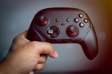 Close-up of a person holding a modern wireless game controller, representing gaming experience, interactive entertainment, technology in hands, and the world of digital play and esports.