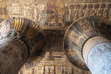Hieroglypic colorful painting carvings on column wall at the ancient egyptian Temple of Khnum in Esna Egypt with ornate decoration