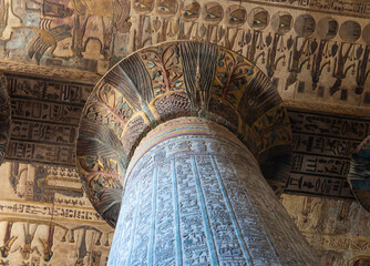 Hieroglypic colorful painting carvings on column wall at the ancient egyptian Temple of Khnum in Esna Egypt with ornate decoration