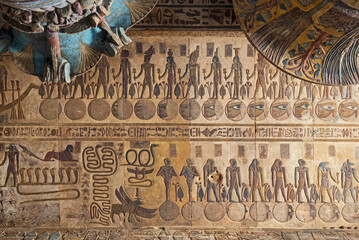 Hieroglypic colorful painting carvings on column wall at the ancient egyptian Temple of Khnum in Esna Egypt with ornate decoration