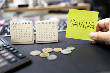 Saving note with coins and 2026 calendar for emergency fund and economic crisis concept. financial discipline, and preparing a budget for the upcoming economic recession and rising cost of living.