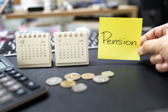 Hand holding Pension note with 2025 and 2026 calendars. retirement planning and financial anxiety. retirement savings crisis, insufficient funds for the elderly, and the stress of financial.