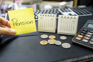 Hand holding Pension note with 2025 and 2026 calendars. retirement planning and financial anxiety. retirement savings crisis, insufficient funds for the elderly, and the stress of financial.