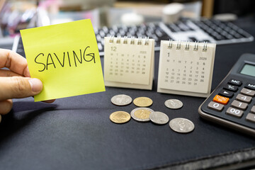 Saving note with coins and 2026 calendar for emergency fund and economic crisis concept. financial discipline, and preparing a budget for the upcoming economic recession and rising cost of living.