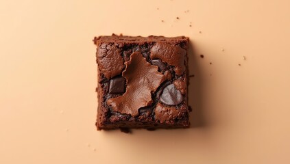 Deliciously rich and fudgy chocolate brownie with decadent chocolate chips, perfectly baked and presented from a top-down view on a warm, inviting background