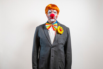 Clown wearing a serious expression and business suit