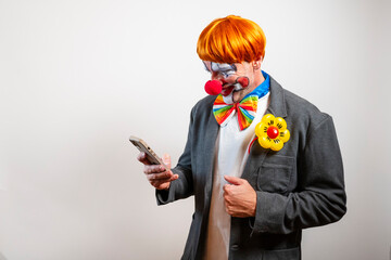 Clown using smartphone checking social media