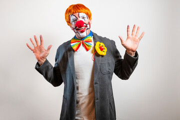 Cheerful clown wearing costume making funny expression