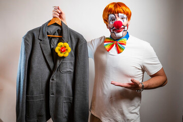 Clown holding costume jacket preparing for performance