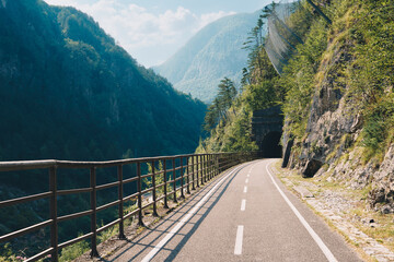 Alpe Adria bicycle trail through alpine mountain valley in Northern Italy