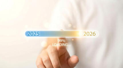 New Year 2026 concept with a hand touching a virtual progress bar showing 99% loading from 2025