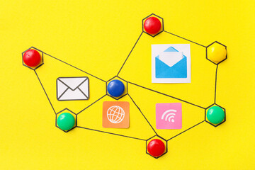 Connected figures with networking symbols on yellow background. Link concept
