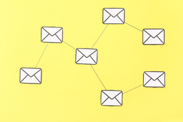 Connected emails on yellow background. Link concept