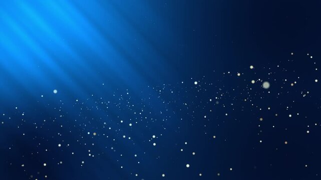 Abstract animated background with glowing gold particles floating in deep blue space, illuminated by soft light rays shining diagonally from the upper left. Elegant, luxury cinematic motion background