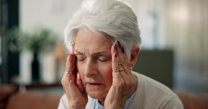Senior woman, headache or stress with pain on sofa for fatigue, old age or mental health in home. Elderly, female person or sore head with migraine or massage for vertigo, strain or pressure in house