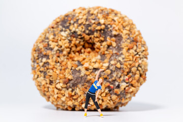Fitness Woman Stretching in Front of Giant Donut