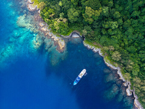Aerial view of ship moored near tropical island